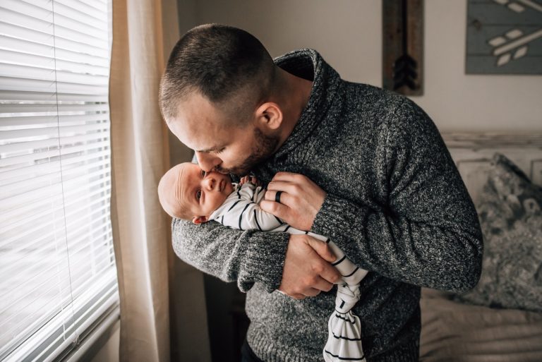 dad kissing baby for in home newborn session