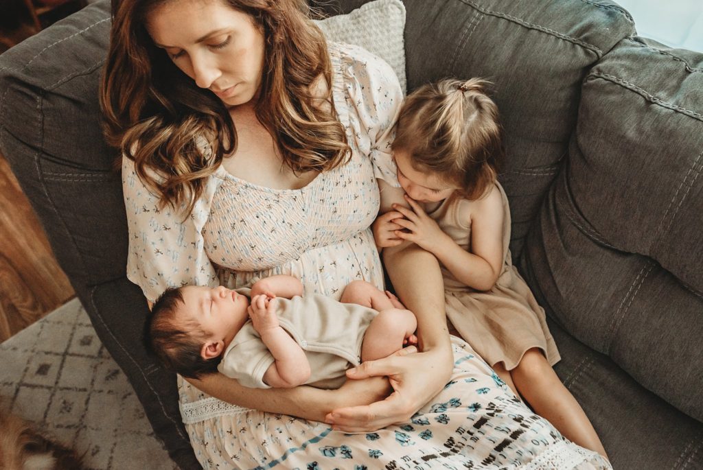 mom holding babies for lifestyle baby session