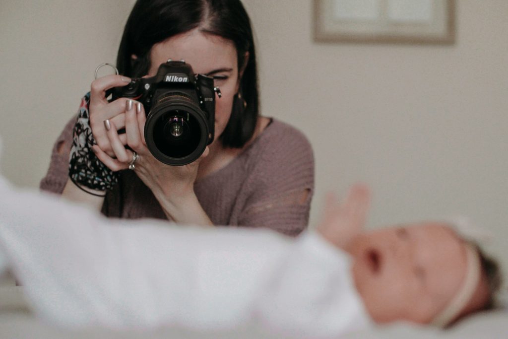 behind the scenes photo of lovecake photography during a newborn session